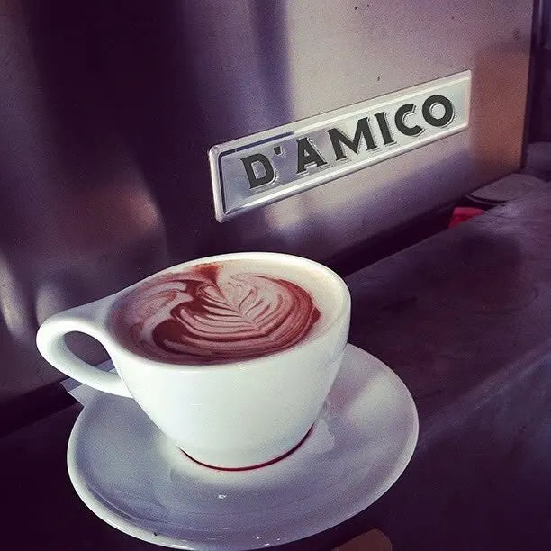 Latte art in front of the D'Amico espresso machine
